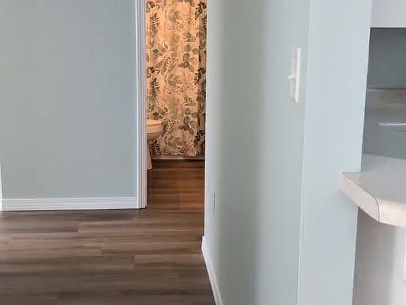 hallway from living areas to hallway bath and 3 bedrooms