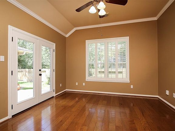 Handsome study with wood floors and french doors lead to side patio.
