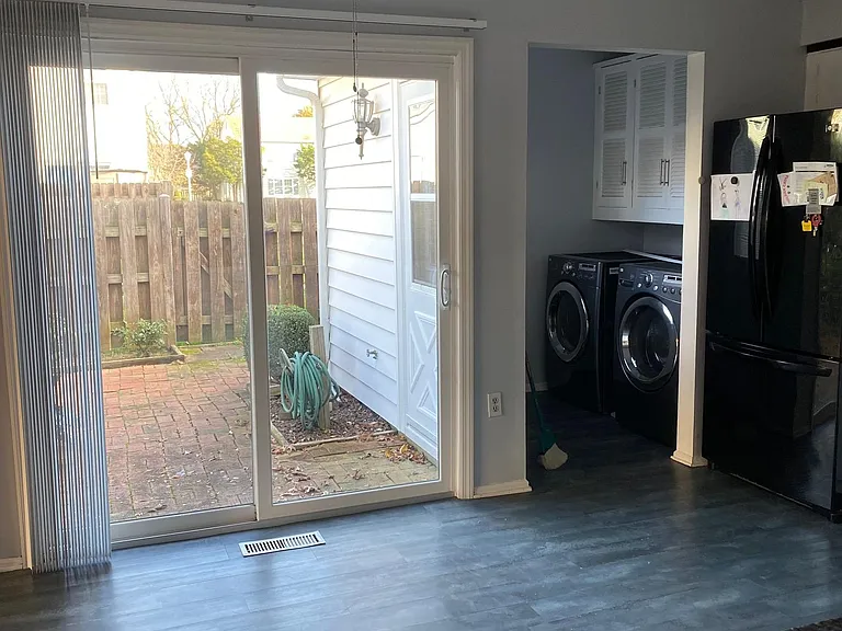 Kitchen with easy access to laundry and sliding door to paved back yard patio
