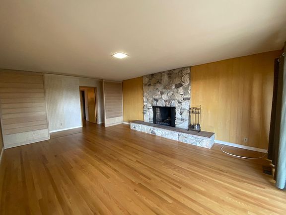 Family room with wood burning fireplace.