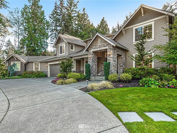 The circular drive with impressive street scape and professional landscaping front and back.