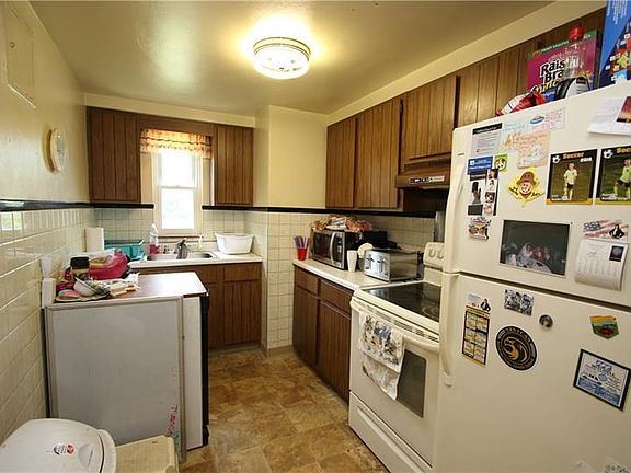 Plenty of Wood Cabinets in 11x7 Kitchen w/ Door to Side Porch