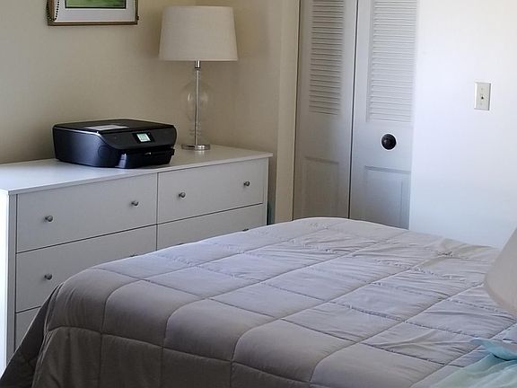 SECOND BEDROOM, FRENCH BALCONY ACROSS FROM THE BED.