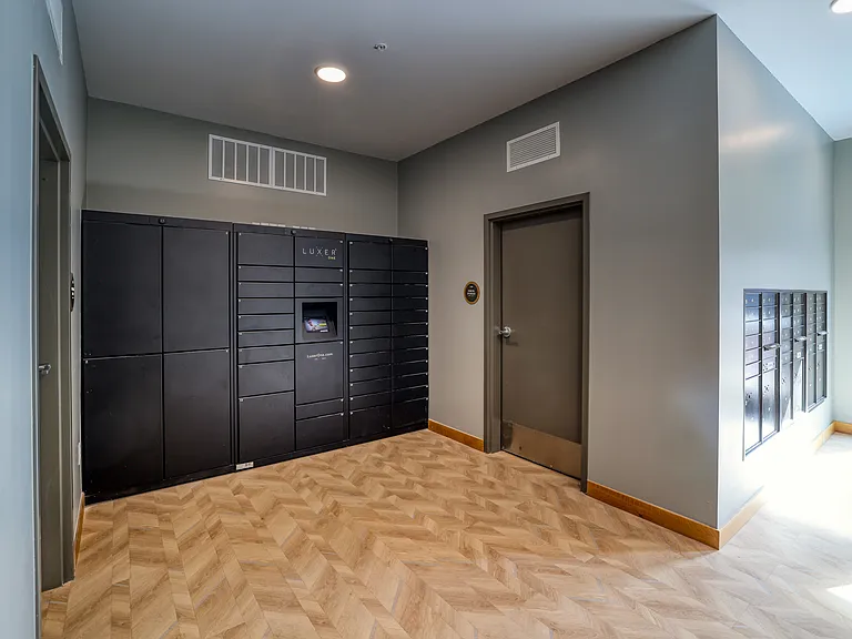 Luxer package lockers and oversized package room in the clubhouse mail room