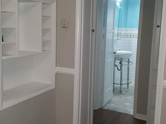Dinning room with original telephone cubby. Hallway with 2 linen closets and storage drawers. Leading into the bathroom. Bedrooms are to the Left and Right.