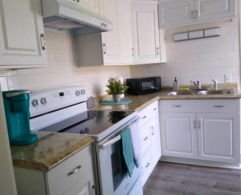 Fully equipped kitchen with stove, cabinets, and essential amenities.