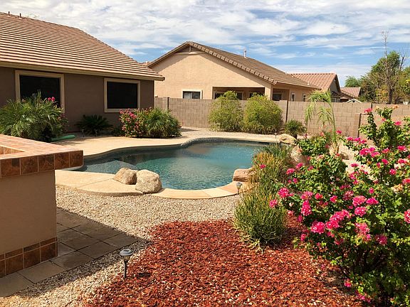 Fun play pool with waterfall and built in BBQ IN BACK, nicely landscaped.