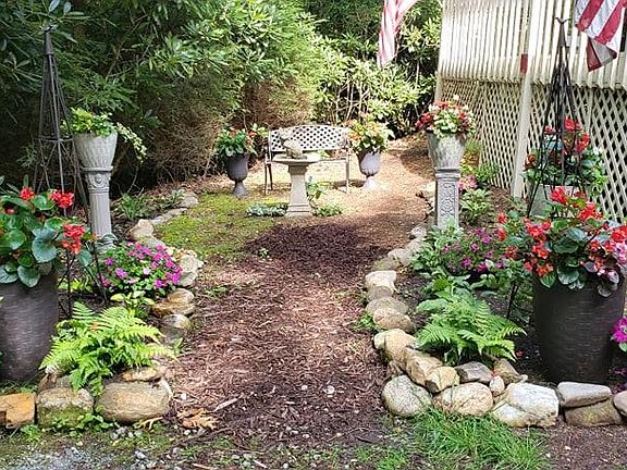 There's a English Styled garden with a bench to relax and enjoy the garden