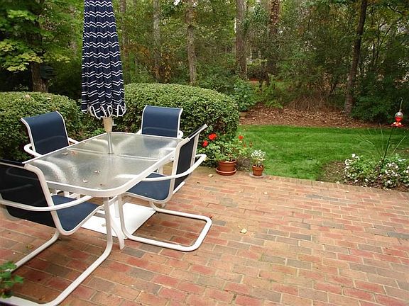 Patio (adjacent to Family Room) with beautiful brickwork and abundant greenery