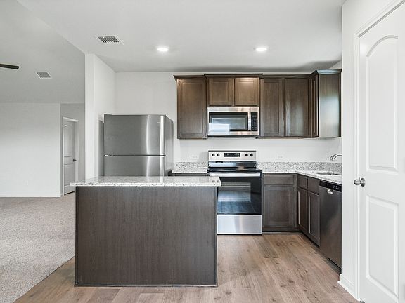 The kitchen of the Sabine has gorgeous wood cabinetry.