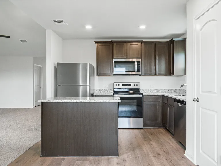 The kitchen of the Sabine has gorgeous wood cabinetry.