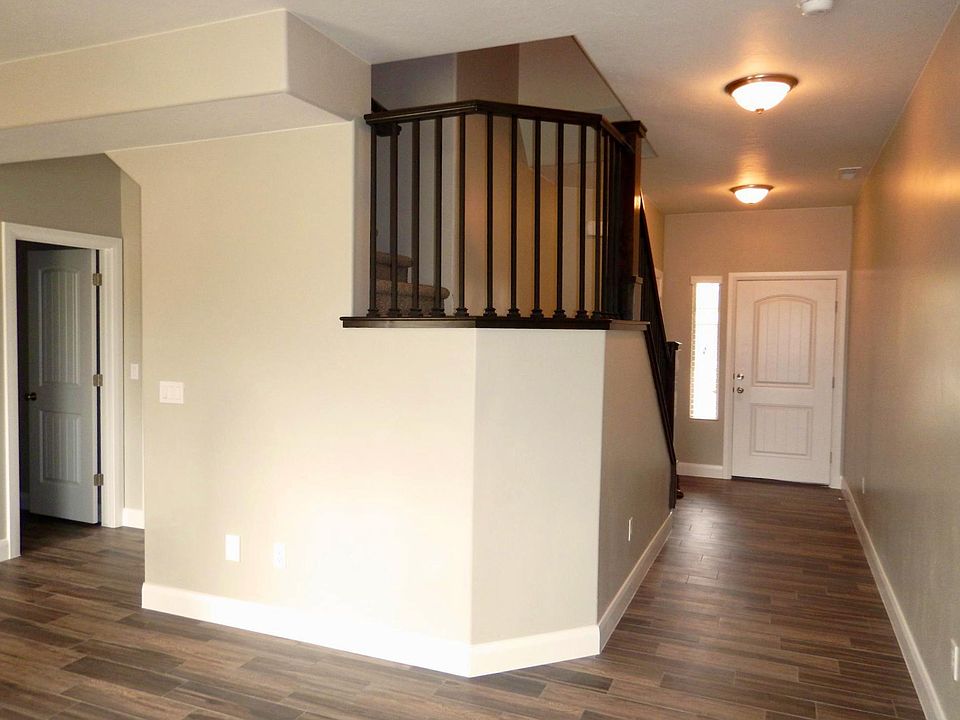 The front door opens to a pleasant foyer leading to the open living, dining, and kitchen area.