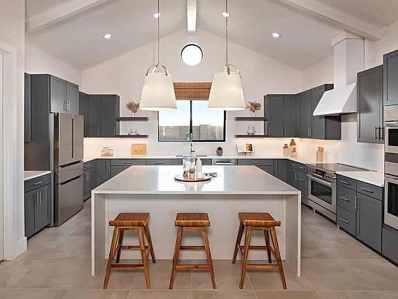 Kitchen with waterfall island and pendant lighting
