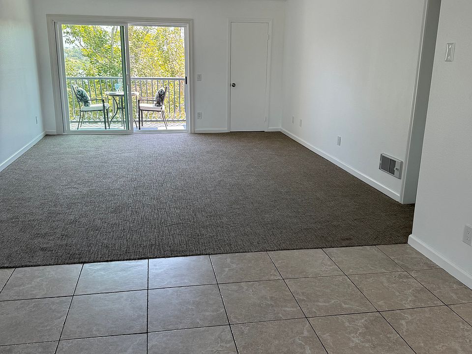 Open concept dining area and living room leading to private balcony with lagoon and ocean views.