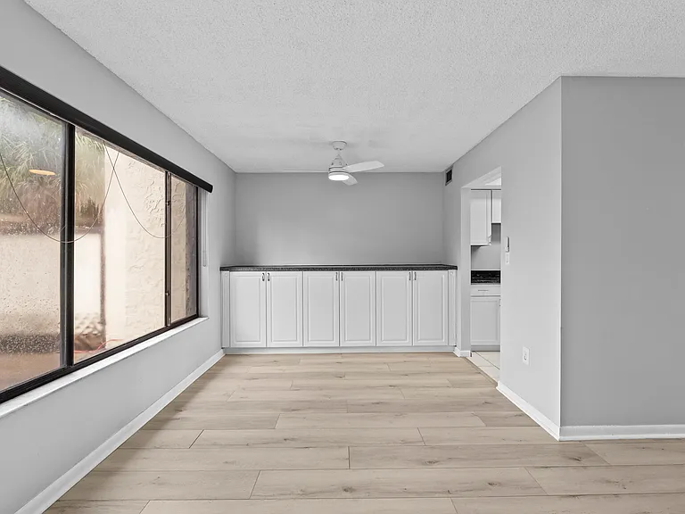 Expansive Living Room/Dining Room area with view of back patio
