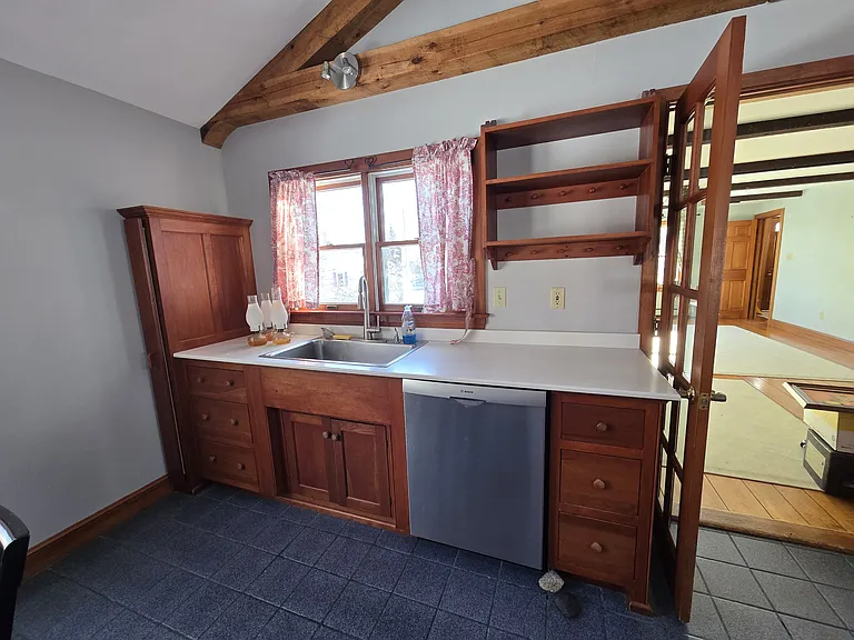 dishwasher and Ironing board storage, french doors leading to dinning room