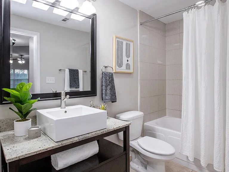 Immerse yourself in glamourous bathrooms with tile flooring, elegant hotel-style sinks, and oversized mirrors, resembling a luxurious and sophisticated retreat. The only difference is you get to live here!