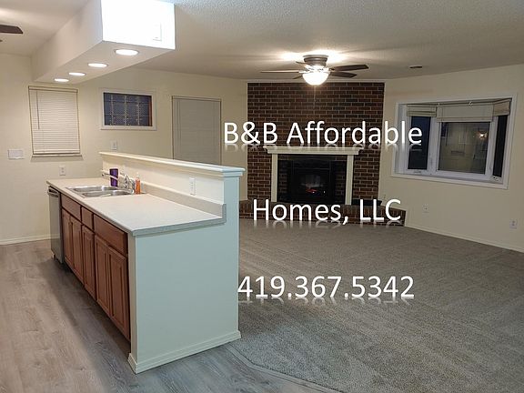 Stainless Dishwasher and Kitchen Sink facing the Family Room