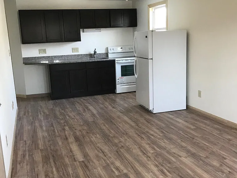 Large kitchenette with stove, full size fridge and granite countertops.