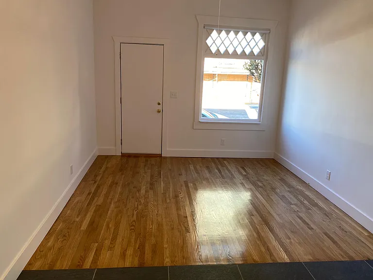 EXPANSIVE LIVING ROOM WIRED FOR CABLE AND GLEAMING NEWLY INSTALLED HARDWOOD FLOORS
