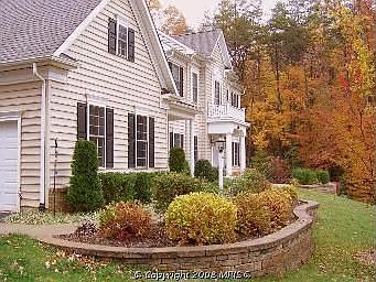 Beautiful Exterior with Custom Walls and 15 zone sprinkler system