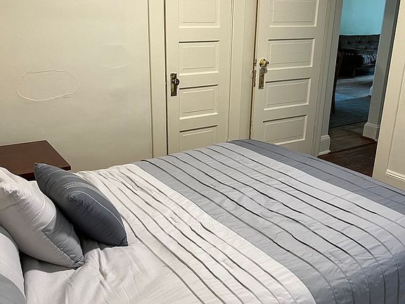 Queen size bed. Computer desk in room