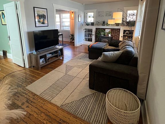 Living room with built in cabinets and old gas stove.