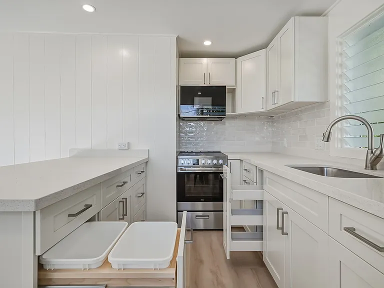 The kitchen features pull out trash and recycle bins plus a spice drawer pullout.