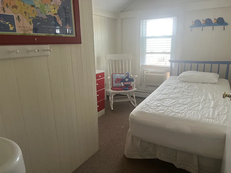 Upstairs oceanfront bedroom with twin bed and in room sink/ vanity