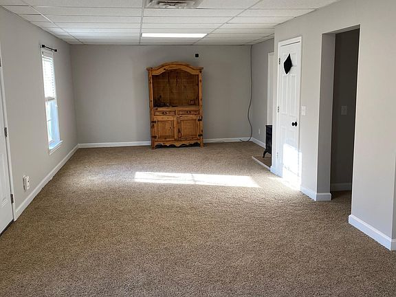 Spacious, open main living area with access to deck and additional storage room