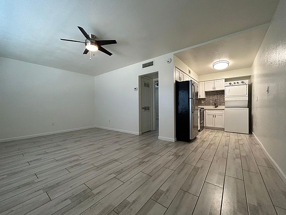 Living room and kitchen area in 1 bedroom with wood look tile throughout! 1st floor unit available