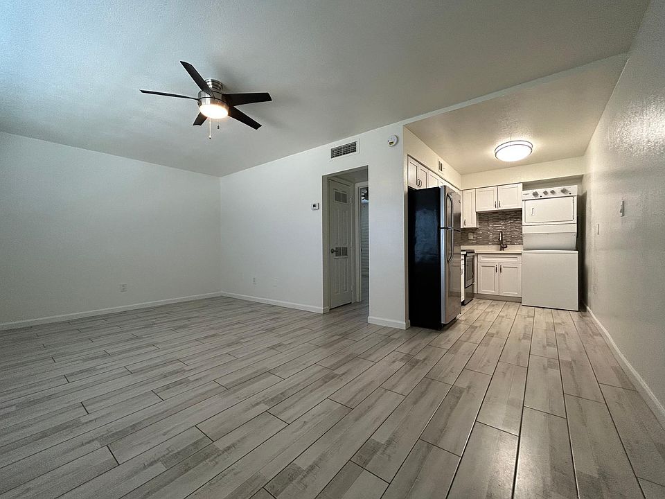 Living room and kitchen area in 1 bedroom with wood look tile throughout! 1st floor unit available