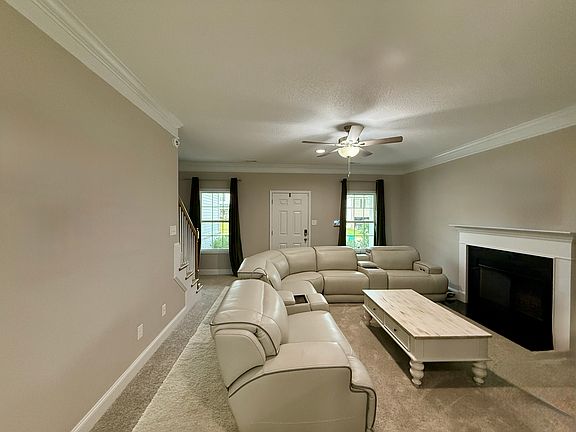 Downstairs livingroom with wood burning fireplace. New leather sectional, 3 reclining chairs in sectional.