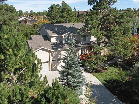 Century-Old Ponderosa Pines & Majestic Spruce Shelter this Lovely Home!