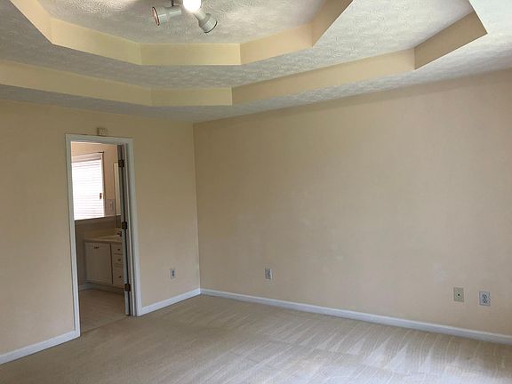 Master bedroom with entrance to master bathroom.