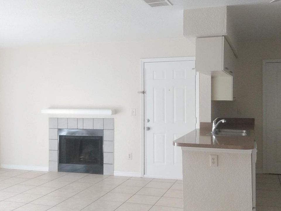 Living room with a fireplace! Entry door.