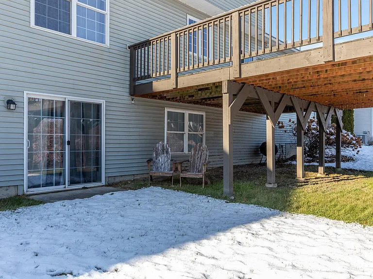 Sliding glass doors/entryway to downstairs bedroom (left) and deck seen from the backyard.