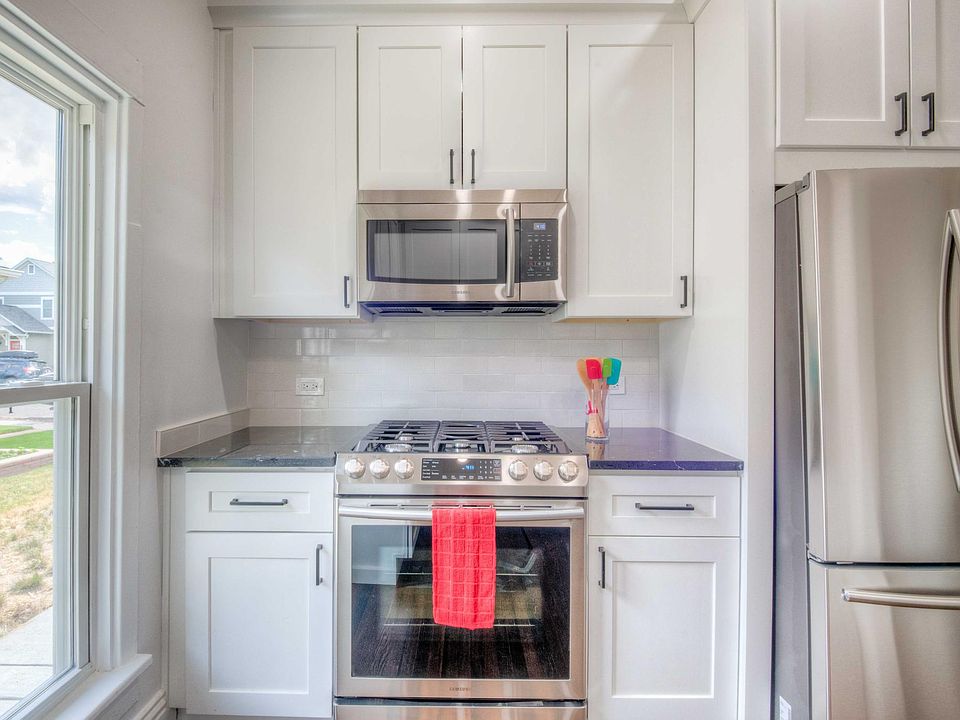 Stove and refrigerator side of kitchen.
