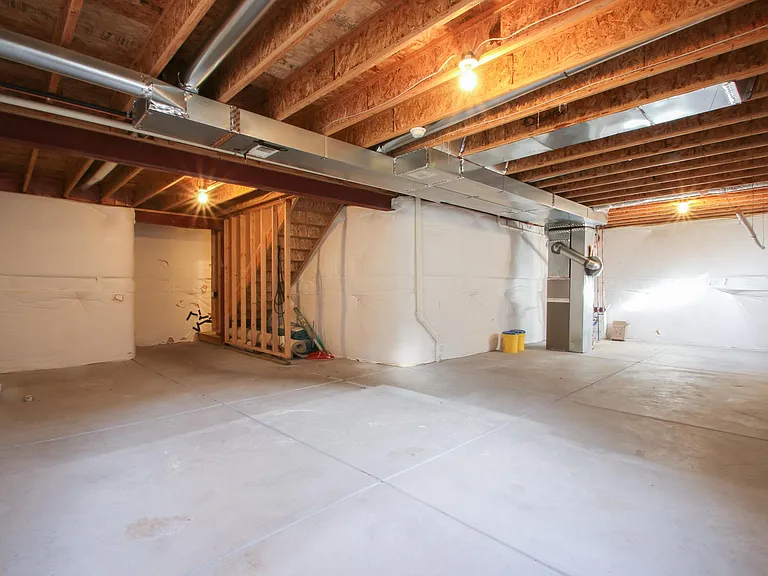 Extensive basement with tall ceilings. Perfect for exercise room, storage space, or play area for children.