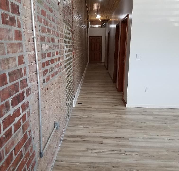 BRICK EXPOSED HALLWAY TO BEDROOMS, KITCHEN AND 2ND BATH