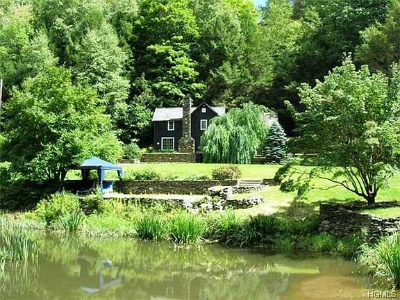 View of home from across the pond, landscaped, also patio