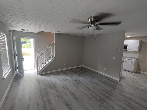 Doorway entrance with stairway leading to bedrooms upstairs. Enter to large living room and kitchen