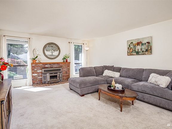 Living room with wood-burning fireplace>