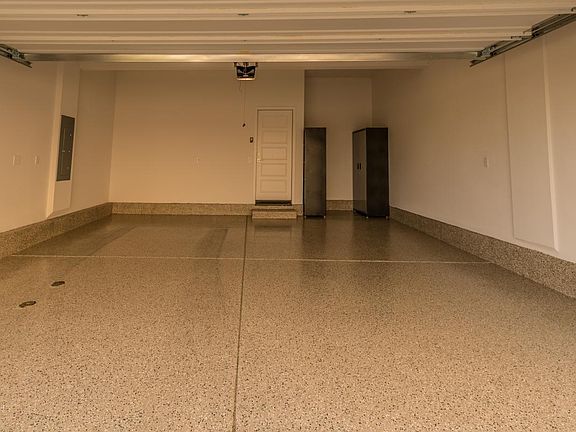 Two-car attached garage with epoxy flooring and steel storag