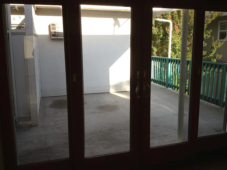 private patio for the unit only. glass and wire screen door.