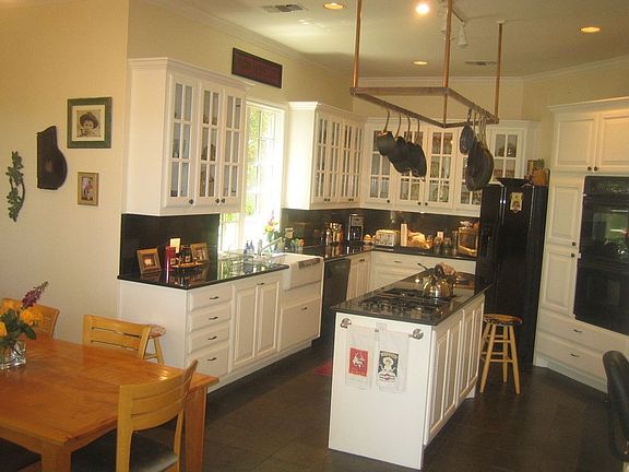Gourmet kitchen with granite counters, slate floors, breakfast nook.