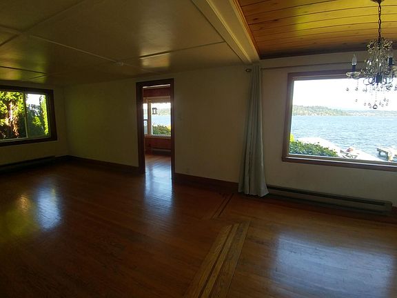 Living and dining area, doorway leads to second bedroom.
