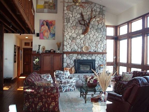 Raised hearth natural stone fireplace centers entertainment space