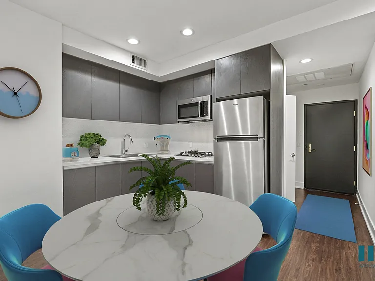 Kitchen with Stovetop, Microwave Oven, Refrigerator, and Dining Area