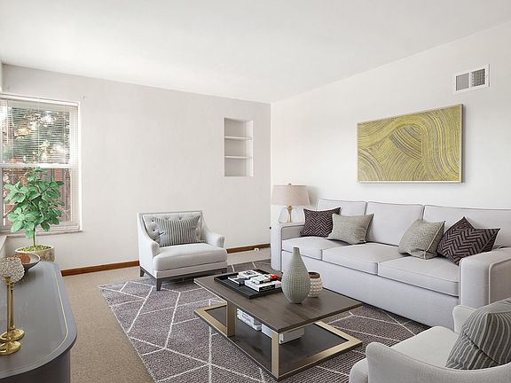 Spacious living room overlooking a tranquil courtyard with stunning landscape. Newly replaced carpet.
